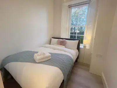 a bedroom with a bed with two towels on it at Adorable 2BR Apartment in Edinburgh