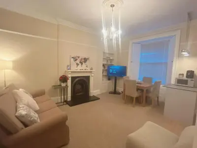 a living room with a couch and a table with a television at Adorable 2BR Apartment in Edinburgh
