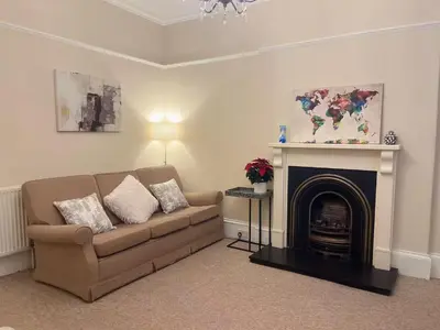 a living room with a couch and a fireplace at Adorable 2BR Apartment in Edinburgh