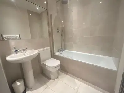 a bathroom with a sink and a toilet and a bath tub at Adorable 2BR Apartment in Edinburgh