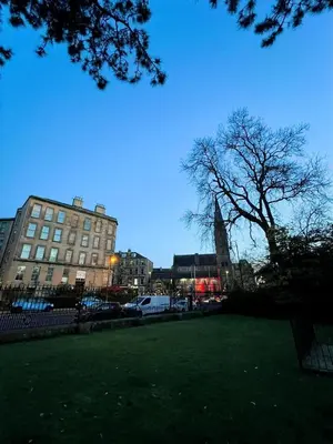 a view of a city with a building and a tree at Heart of West End apartment, Glasgow in Glasgow