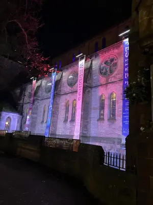 a building lit up with purple and blue lights at Heart of West End apartment, Glasgow in Glasgow