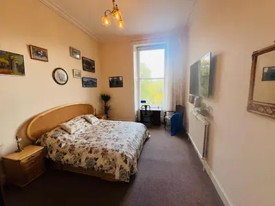 a bedroom with a bed and a window at Heart of West End apartment, Glasgow in Glasgow