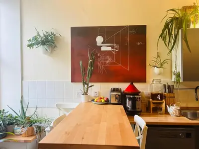 a kitchen with a wooden table and some plants at Heart of West End apartment, Glasgow in Glasgow