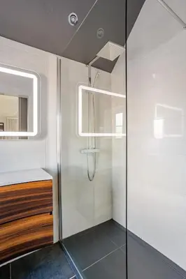 a bathroom with a shower and a sink and a mirror at Edwardian Manor hot tub & Pool in Glasgow, Gated in Giffnock