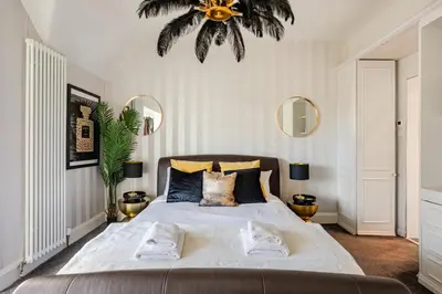 a bedroom with a large bed with two mirrors at Edwardian Manor hot tub & Pool in Glasgow, Gated in Giffnock