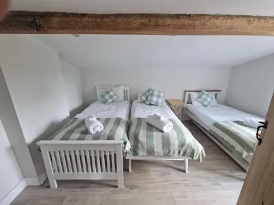 two twin beds in a room with at The Old school House in Moffat