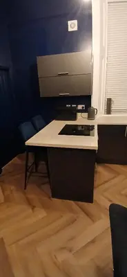 a kitchen with a stove and a wooden floor at 89A Bank Street 3 bedroom in Jamestown