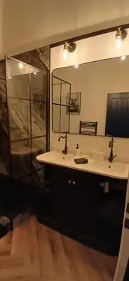 a bathroom with a sink and a mirror at 89A Bank Street 3 bedroom in Jamestown