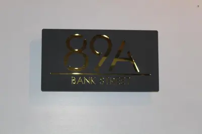 a black sign with the number on it at 89A Bank Street 3 bedroom in Jamestown