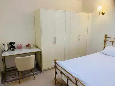 a bedroom with a bed and a desk and a chair at Cozy Room in Glasgow in Glasgow