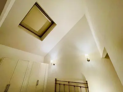 a bathroom with a mirror on the wall and a bed at Cozy Room in Glasgow in Glasgow