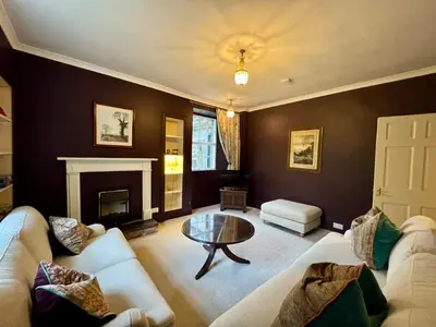 a living room with two couches and a table at Estate Getaway at Powis House Estate in Stirling