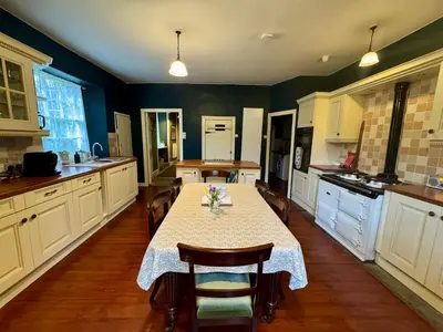 a kitchen with a table and chairs in it at Estate Getaway at Powis House Estate in Stirling