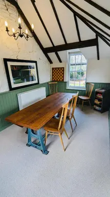 a large wooden table in a room with chairs at Estate Getaway at Powis House Estate in Stirling