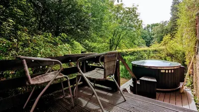 a pair of chairs and a barrel on a deck at Estate Getaway at Powis House Estate in Stirling