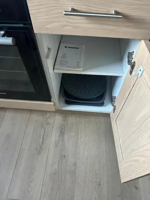 a drawer in a cabinet with a microwave in it at The Skipper's Rest in Millport