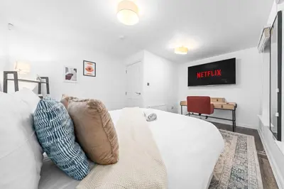 a white couch with pillows in a living room at Urban Elegance - Spacious 5-Bed Home in Glasgow in Glasgow