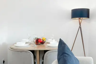 a table with a bowl of fruit and a lamp at Fraser Apartment- 2 Bedrooms Inverleith, Edinburgh in Edinburgh