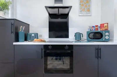 a kitchen with a stove and a microwave at Fraser Apartment- 2 Bedrooms Inverleith, Edinburgh in Edinburgh