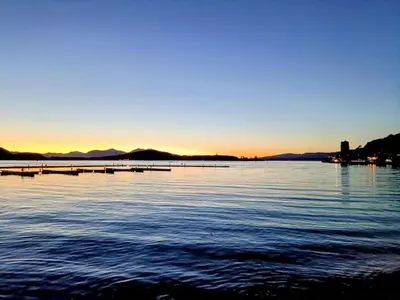 a view of a large body of water at sunset at Bay View Apartment in Oban