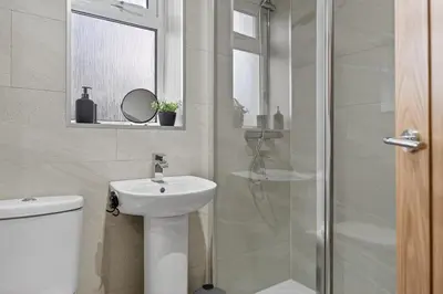 a bathroom with a toilet and a sink and a shower at The Hide - Suburban Terraced Home in Horse Isle
