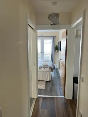 a bedroom with a bed in a room with a window at Canal View Cottage in Winchburgh