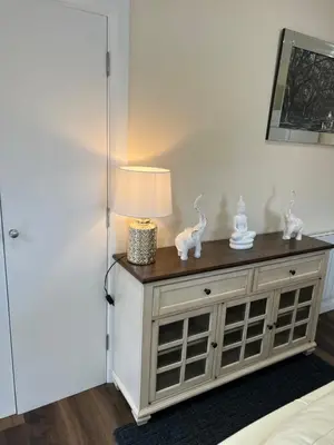 a lamp on top of a dresser in a room at Canal View Cottage in Winchburgh
