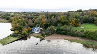 an aerial view of a house on an island in the water at Cosy Lodge Getaway with Private Beach & Fireplace in Erskine