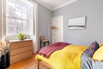 a bedroom with a bed and a dresser and a window at Edinburgh, DeanVillage Cosy Hideaway Apartment in Edinburgh