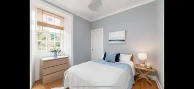 a bedroom with a bed and a window at Edinburgh, DeanVillage Cosy Hideaway Apartment in Edinburgh