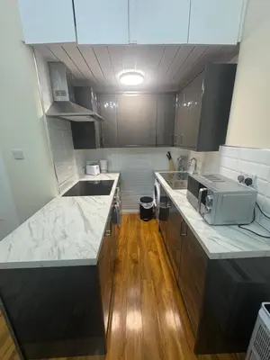 a kitchen with a sink and a microwave at Glasgow - Cosy 1 Bedroom Apartment in Glasgow