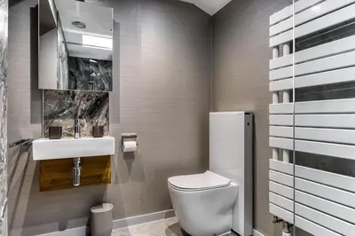 a bathroom with a toilet and a sink at Courtyard Cottage in Castle Douglas