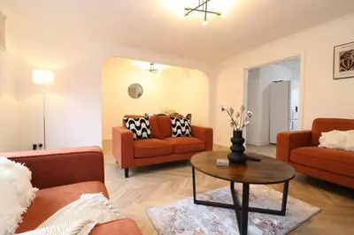 a living room with two couches and a table at Modern 3BR Home with Parking in East Kilbride