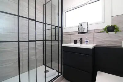 a bathroom with a sink and a shower at Modern 3BR Home with Parking in East Kilbride