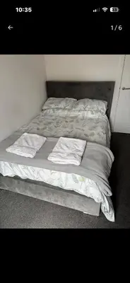 a bed with two pillows on top of it at Room in shared flat in Edinburgh