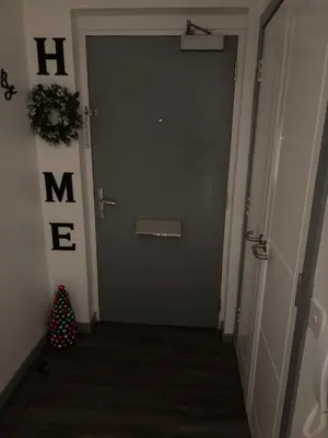 a hallway with a door with a christmas tree on it at Room in shared flat in Edinburgh