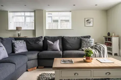 a living room with a couch and a coffee table at Old School Mews - Shanklin - Dog Friendly in Moffat