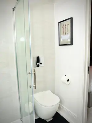 a bathroom with a toilet and a glass shower at Premium 4BR I Near Golf Course I Fast Wi-Fi & Free Parking in Moffat