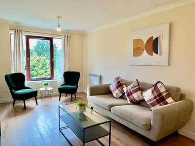 a living room with a couch and two chairs at Garden-View 2BR Apartment - Free Parking & WiFi in Glasgow