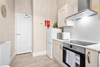 a kitchen with white appliances and a white refrigerator at Welcoming Home In Renfrew, Near Glasgow Airport - Bonnie Lodgings in Renfrew