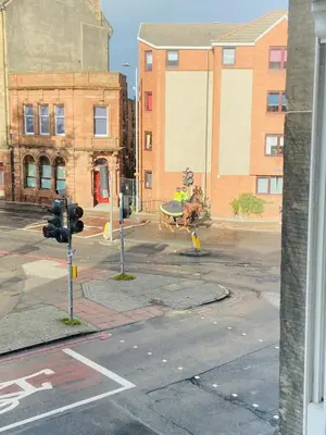 a horse pulling a cart on a city street at Two-bedroom city retreat close to top sites in Edinburgh