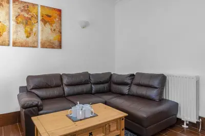 a living room with a leather couch and a coffee table at Executive 3 Bedroom - Corporate And Contractor Stays in Glasgow