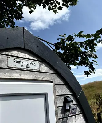 a sign on the side of a wooden door at Pentland View Campsite in Haywood
