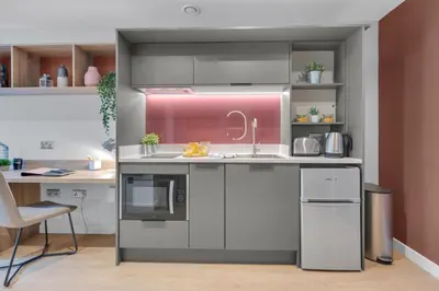 a kitchen with a sink and a stove at The Bonnie in Glasgow