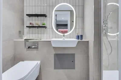 a white bathroom with a sink and a mirror at The Bonnie in Glasgow