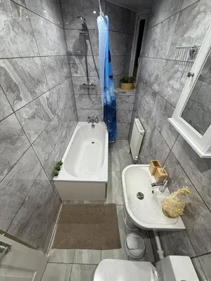 a bathroom with a tub and a sink and a toilet at Glasgow centre New property in Glasgow