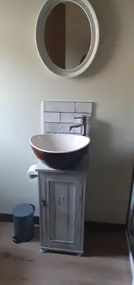a bathroom with a sink and a mirror at Carrick Chalets in Cairndow