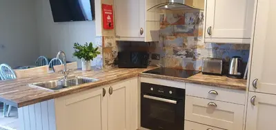 a kitchen with a sink and a counter top at Carrick Chalets in Cairndow