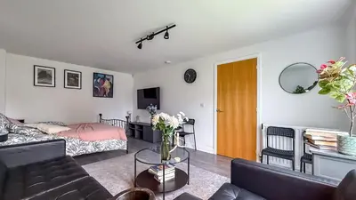 a living room with a couch and a table at New Modern Detached House with 5bdr Glasgow in Renfrew